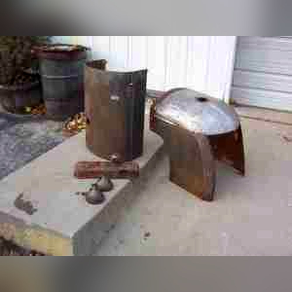 Antique tractor parts chemically stripped down to bare metal in the Strip-o-lator at Doll Furniture Company — we strip metal parts, not just furniture