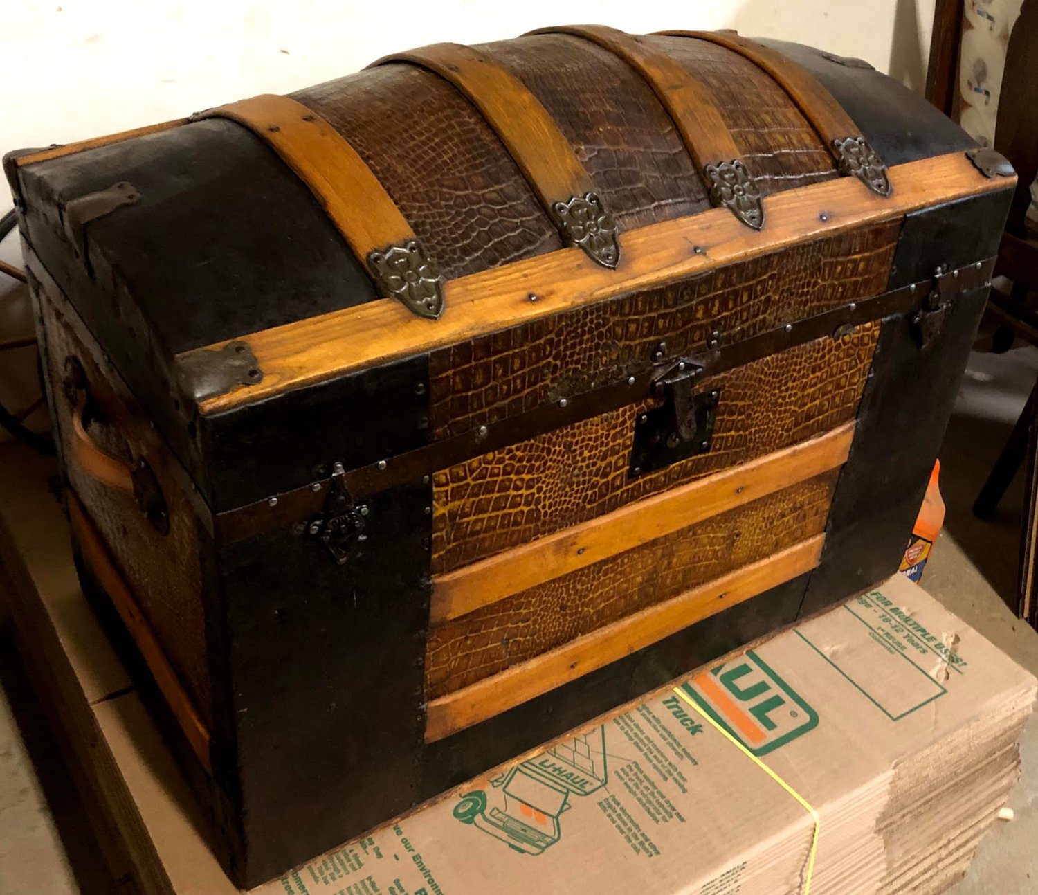 Victorian dome-top steamer trunk fully restored at Doll Furniture Company — embossed alligator-pattern panels, oak slats, and original cast-iron hardware brought back to life